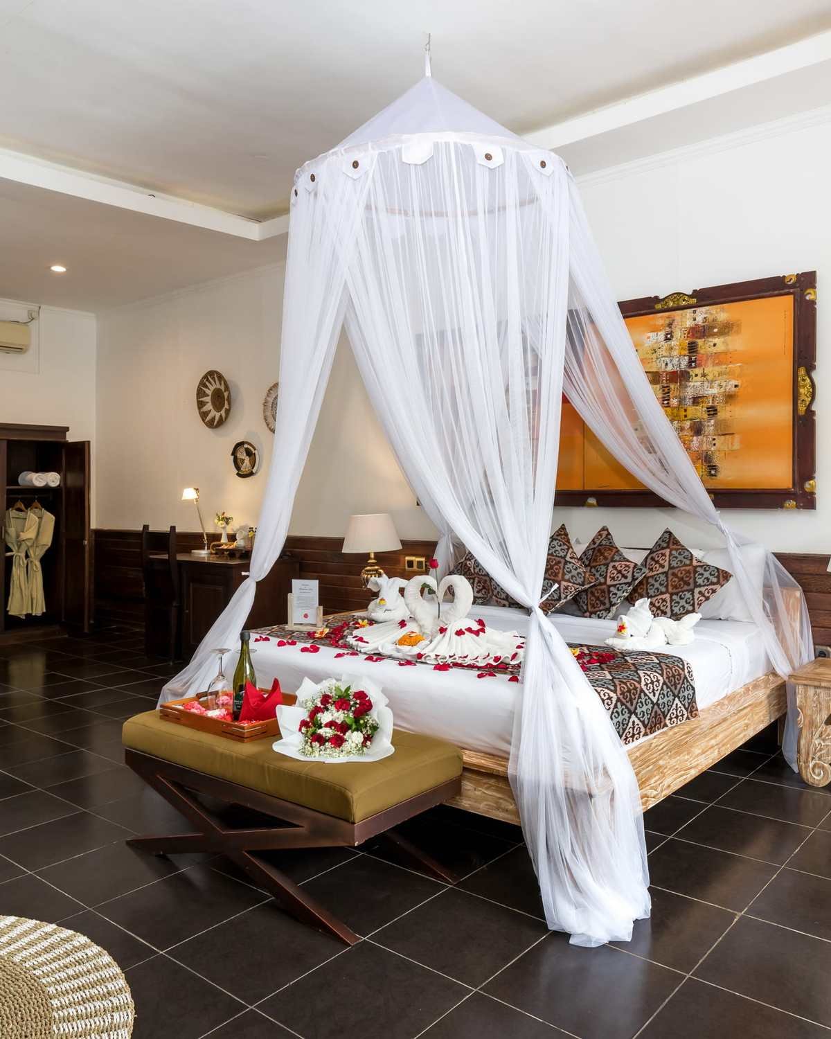 Deluxe Room with a canopy king bed at Ubud Raya Boutique Hotel