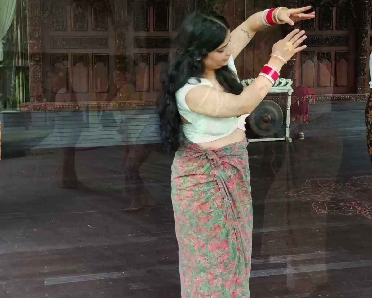 A dancer demonstrating Balinese dance in the teak pavilion at Ubud Raya Resort