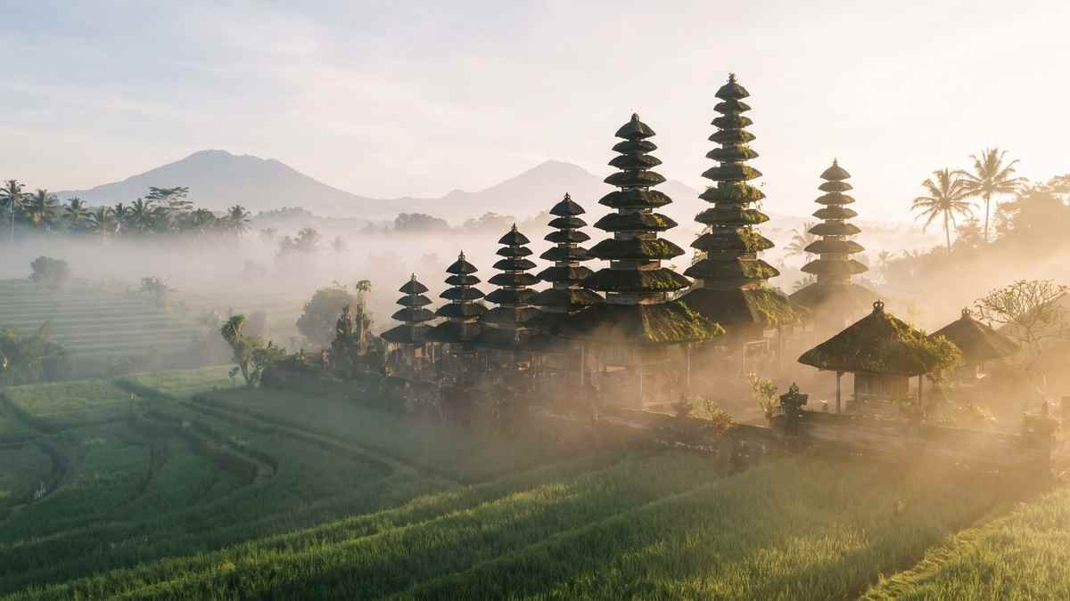 Illustration of Balinese meru roofs rising out of morning mist