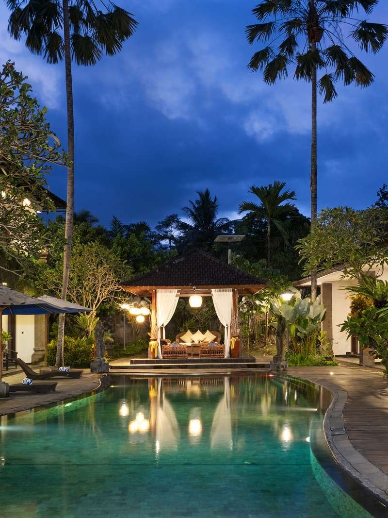 The pool and lantern-lit gazebo at Ubud Raya Boutique Hotel at blue hour